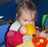 photo of a girl drinking at snack time in Dragonflies, Longscroft