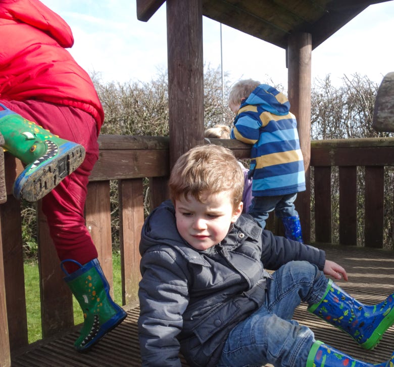 Photo of boys climing in outdoor area at Longscroft Nursery