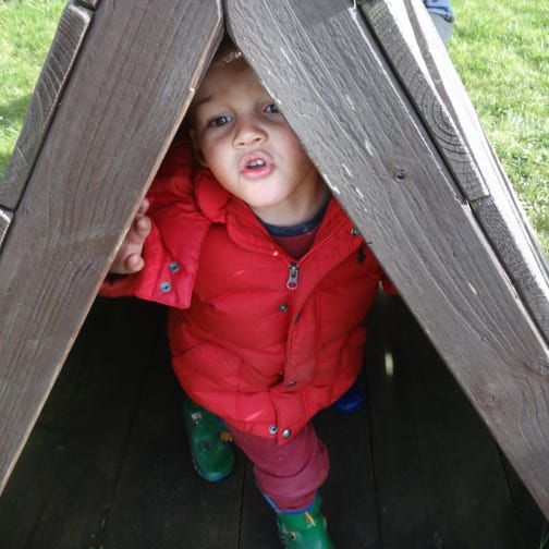 Photo of a boy in wooden outdoor play area at Longscroft Nursery