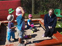 photo of children from Dragonflies playing in a sandpit at Longscroft