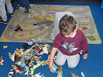 photo of&nbsp; boy in Dragonflies playing with dinosaurs at&nbsp; Longscroft
