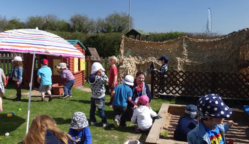Photo of summer play in the gardens at Longscroft Nursery