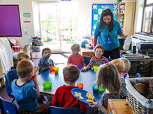 photo showing children sitting down to snacks at Longscroft
