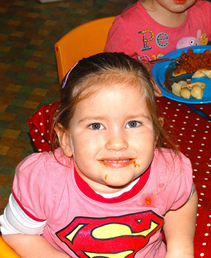Girl in Ladybirds room, Longscroft, eating luch 